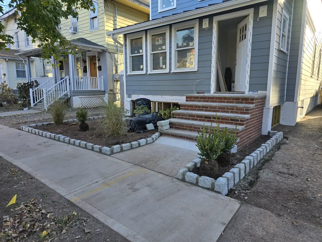 Completed brick entry, Belgian-block edging, and front garden
